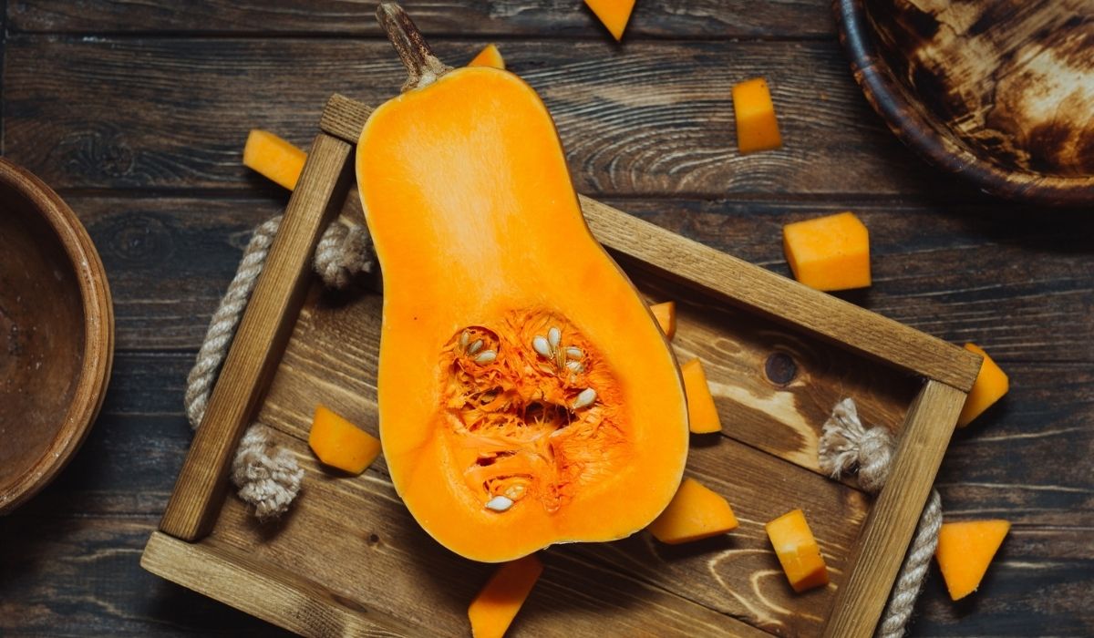 Butternut squash with seeds on wooden tray