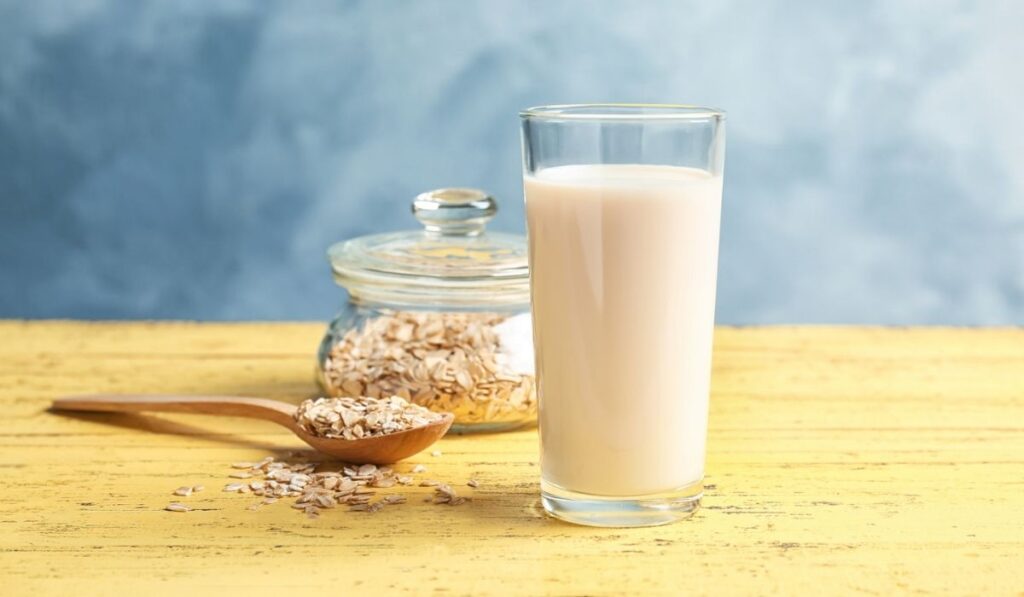 Glass with oat milk and flakes