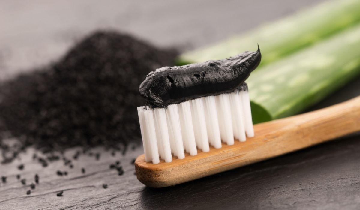 Toothbrush with black charcoal toothpaste with aloe vera