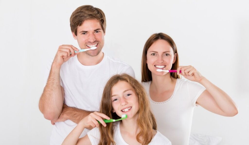 Family Brushing Teeth Together 
