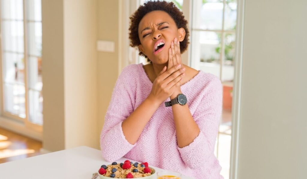 Young african american woman having healthy breakfast in the morning 