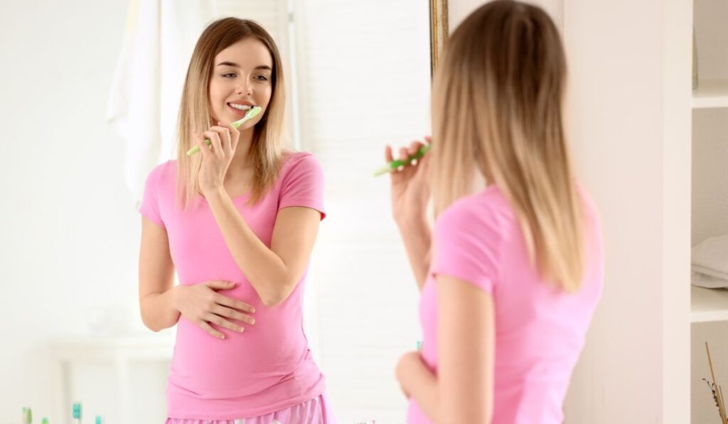 Beautiful young woman brushing her teeth in morning 