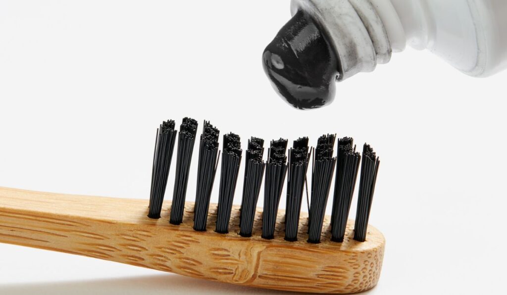 Toothbrush with black charcoal toothpaste 