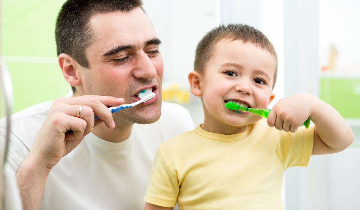 Father and kid son brushing teeth