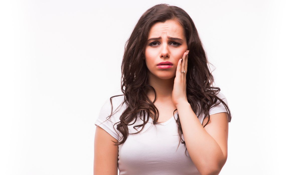 Woman suffering from jaw pain, toothache, tooth sensitivity