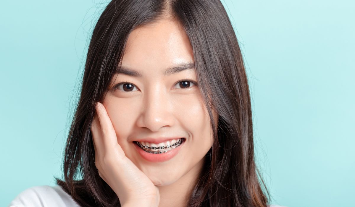 Dental braces of young asian woman wearing braces beauty smile with white teeth