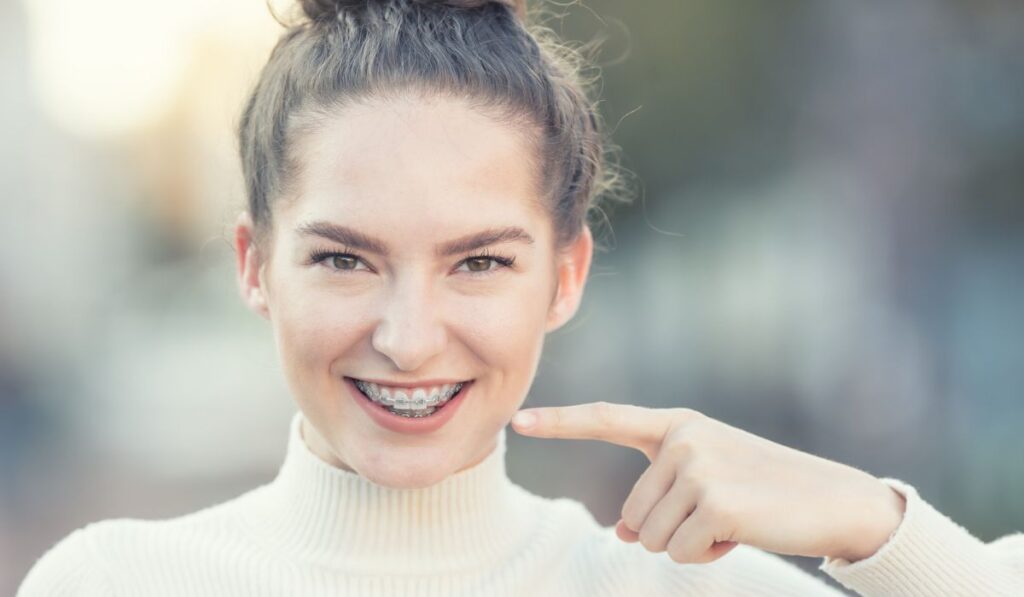 Portrait of a happy smiling young woman with dental braces