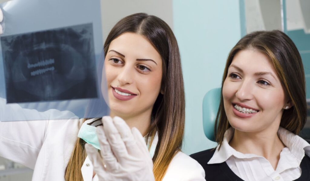 Female dentist holding x-ray, dental scan