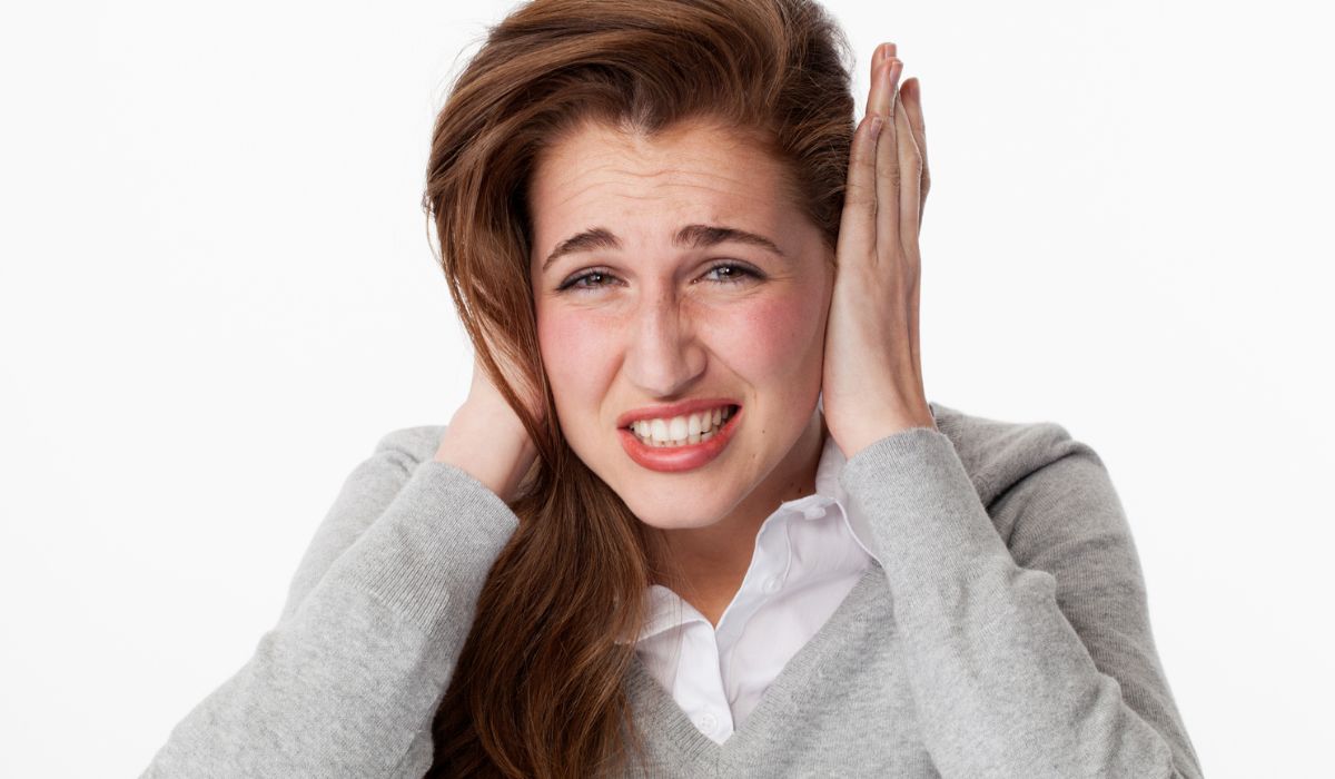 Woman suffering from headache grinding teeth