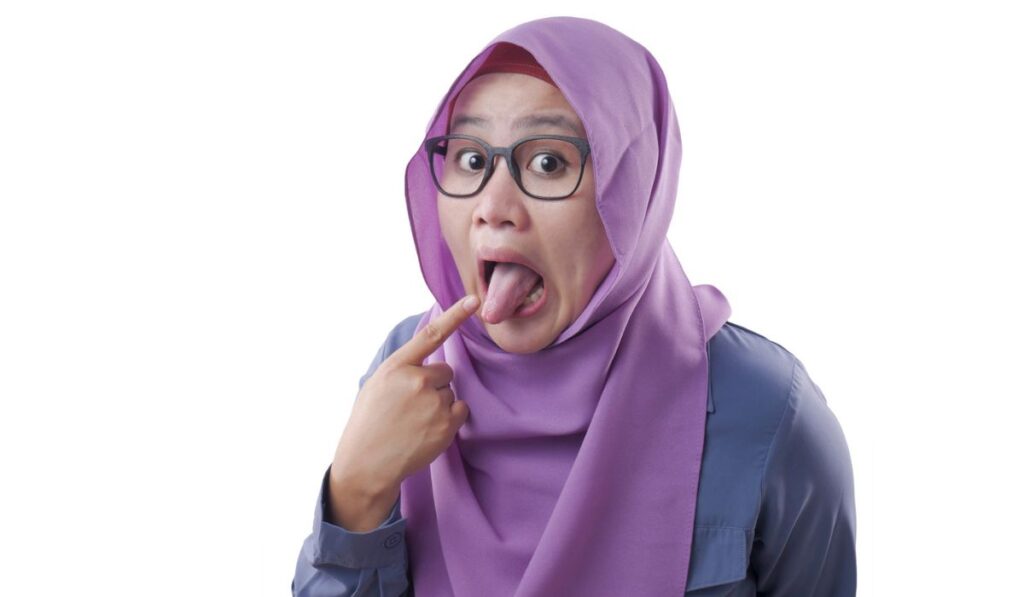 Muslim Woman Pointing at Her Toungue