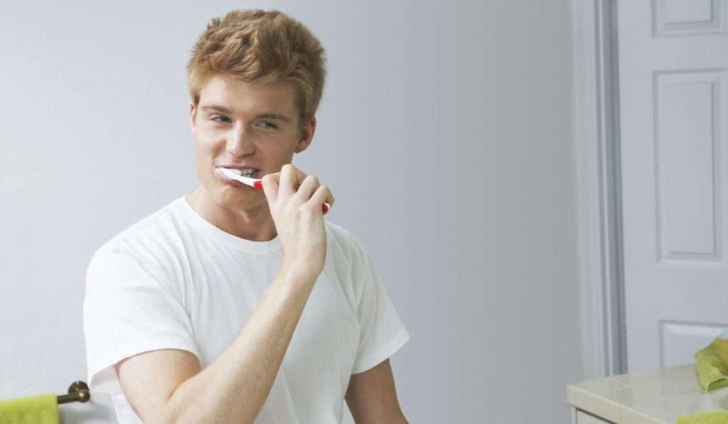 Young Man Brushing His Teeth