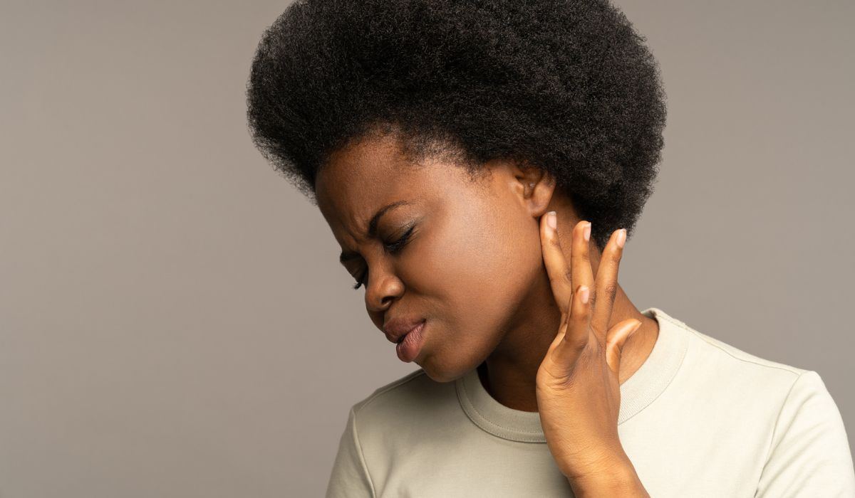 Sick african girl checking lymph nodes with finger